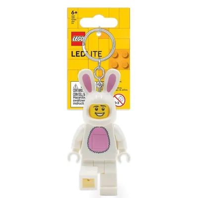 A LEGO minifigure keychain in a bunny costume, attached to its yellow and orange LEGO branded packaging.