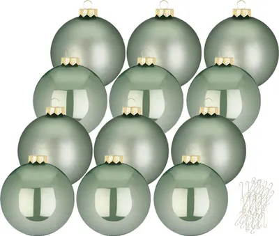 A collection of twelve sage green Christmas ornaments arranged in a grid pattern, with a small pile of ornament hooks in the bottom right corner.