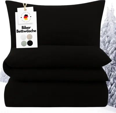 A stack of black bedding with a tag showing color swatches and German flag.