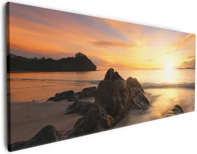 Produktbild von Wallario Premium Leinwandbild Sonne über dem Meer mit Felsenlandschaft in Größe 60 x 150 cm