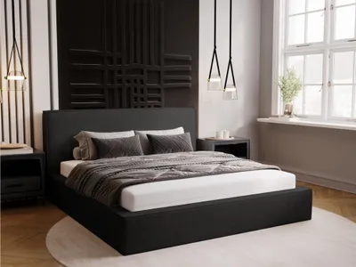 A modern bedroom with a large bed, bedside tables, and decorative wall art.