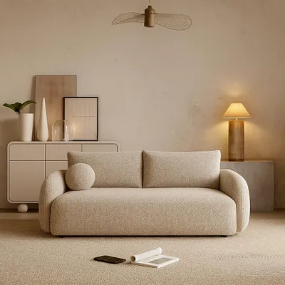 A modern living room scene featuring a sofa, a cabinet, and decorative items.
