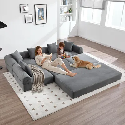 A family and their dog relaxing on a modular sofa in a living room.