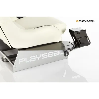 Close-up of a white racing seat with a silver base and a black gearshift holder attachment.