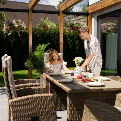 A couple enjoying a meal at a table on a patio.