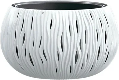 A white, decorative planter with a wavy, cut-out design.