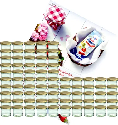 A collection of small glass jars with gold lids, arranged in rows, with some decorative elements like flowers and a packet of jelly powder in a basket.