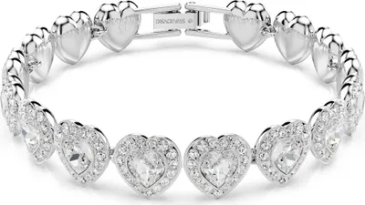 A close-up studio shot of a silver bracelet with heart-shaped charms.