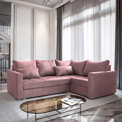 A pink sectional sofa is shown in a well-lit living room with large windows and sheer curtains.