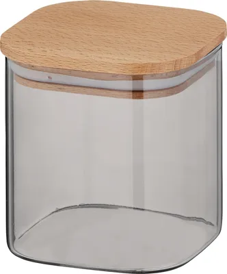 A clear studio shot of a glass kitchen container with a wooden lid.