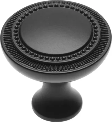 A black, round cabinet knob with a textured rim and beaded detail.