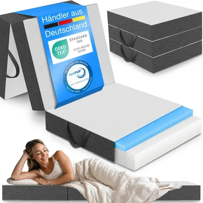 A woman is lying on a mattress, with a mattress box and a folded mattress shown in the background.