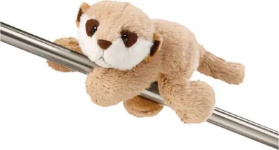 A plush meerkat toy is draped over a metal bar.