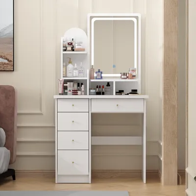 A white vanity table with a lighted mirror and various makeup products displayed.