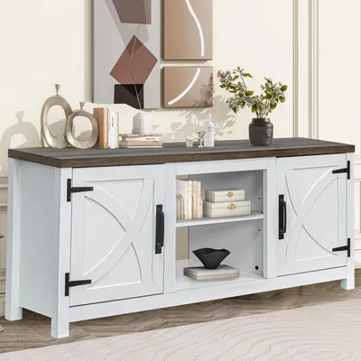 A white TV stand with a dark wood top, featuring two cabinet doors with 'X' designs and two open shelves in the center. It is decorated with books, boxes, and a black bowl.