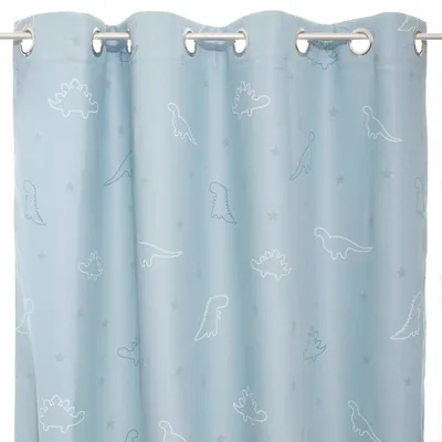 A close-up view of a blue curtain with a dinosaur pattern.