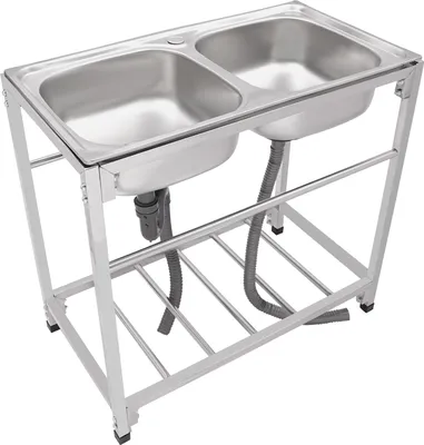 A stainless steel double sink with a metal frame and drainage pipes.