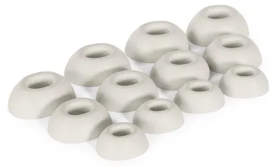 A collection of white silicone earbud tips arranged in rows on a white background.