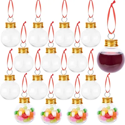 A collection of clear plastic Christmas ornaments filled with candy and liquid, arranged in rows on a white background.