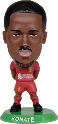 A bobblehead figure of a soccer player on a green base.