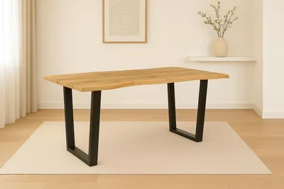 A dining table with a live edge wood top and black metal V-shaped legs, placed on a rug in a well-lit room.