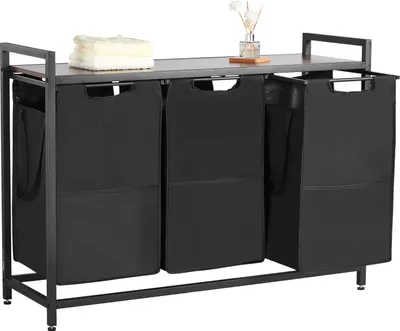 A laundry sorter with a wooden top shelf and three black fabric bins, set against a white background.