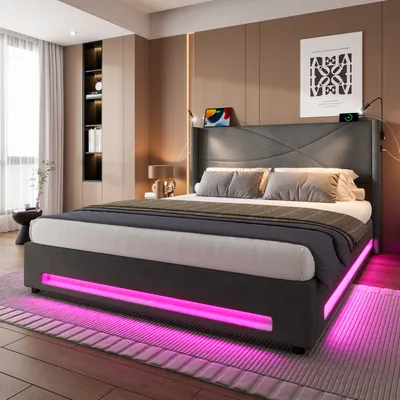 A modern bedroom with a bed featuring LED lighting.