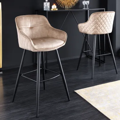 Two bar stools in a modern interior setting with a dark wall and wooden floor.