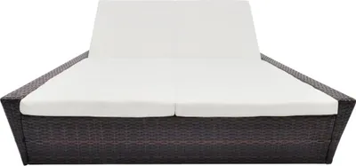 A double lounge bed with white cushions on a white background.