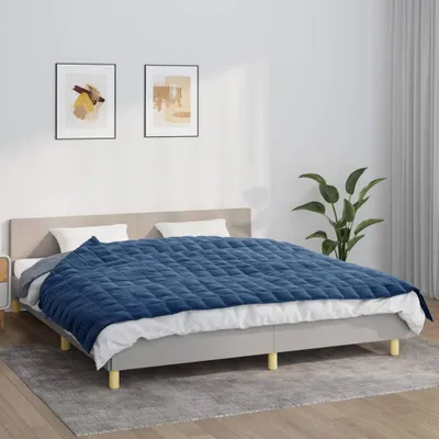 A bedroom scene with a bed, pillows, and a blanket.