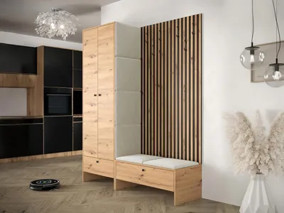 A modern entryway or hallway with a wardrobe and bench set, featuring wood and upholstered panels, next to a kitchen area.