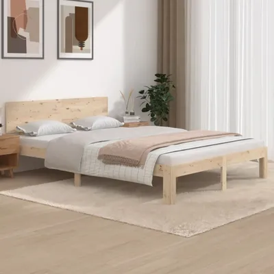 A bedroom scene with a wooden bed frame and bedding.