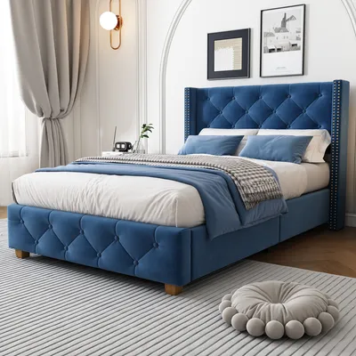 A bedroom setting with a blue upholstered bed.