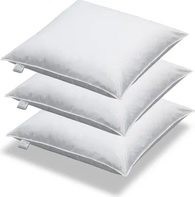 Three white pillows stacked on top of each other.