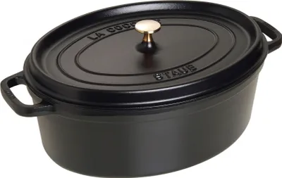 A black oval cast iron pot with a gold knob on the lid.