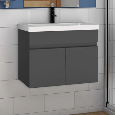 A modern gray vanity with a white sink and a black faucet mounted on a tiled wall.