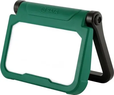 A green and black industrial floodlight with a white light panel.