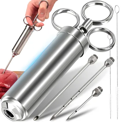A hand is holding a meat injector, with other parts of the set displayed around it.