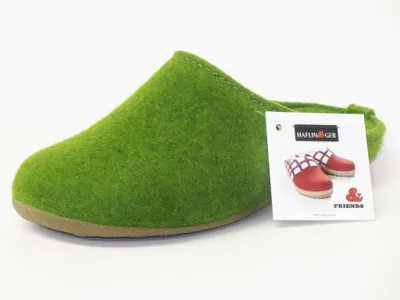 A green slipper with a product tag next to it.