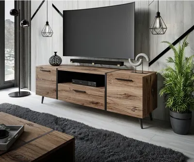 A modern living room with a TV stand, television, and decorative items.