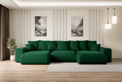 A spacious living room with a large green sectional sofa.