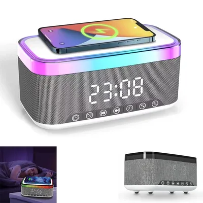 A digital alarm clock with a wireless charging pad and LED lights, with a smartphone placed on top.