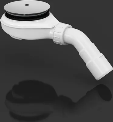 A white shower drain with a chrome cover against a dark background.