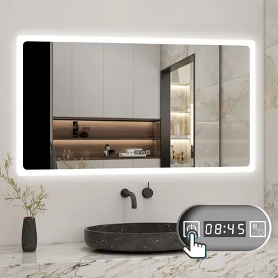 A modern bathroom with a large LED mirror over a sink. A control panel with a clock is visible.