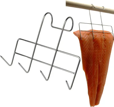 A stainless steel fish smoking rack with a piece of salmon attached, hanging from a wooden rod.