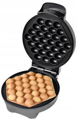 An open waffle maker with cooked bubble waffles on the bottom plate.