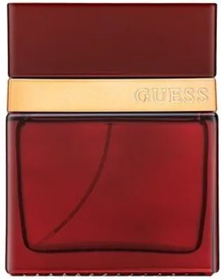 A close-up studio shot of a red Guess Seductive Red Eau de Toilette bottle with a gold band.