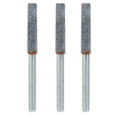 Three cylindrical grinding stones with metal shafts, arranged vertically.