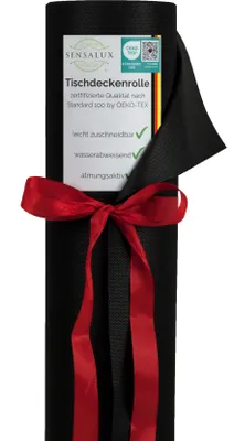 A black roll of tablecloth material tied with a red ribbon, with a label attached.