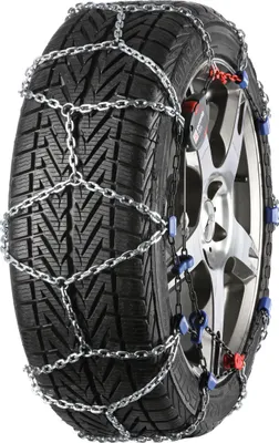 A snow chain is fitted to a car tire.